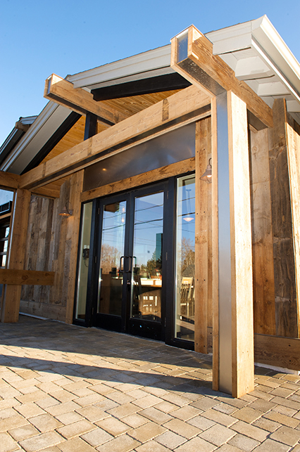 the exterior doors of 10 Barrel framed by heavy wooden exposed beams